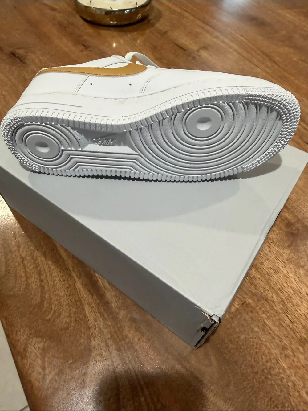 Nike Women's White Sneakers with Gold Swoosh